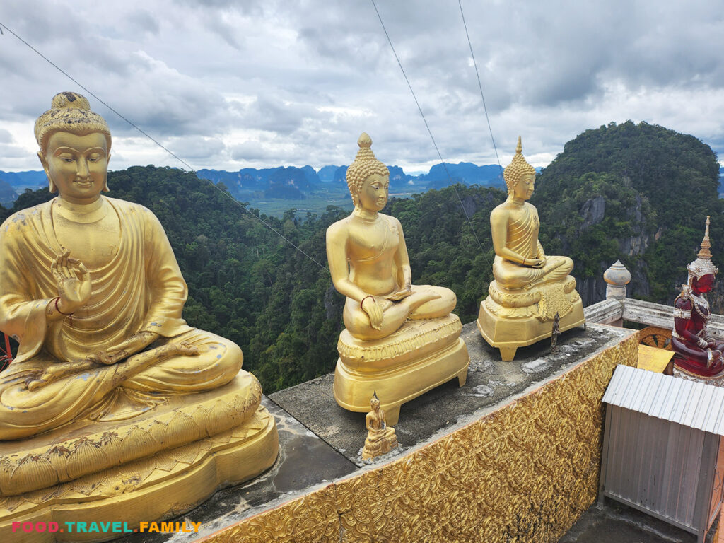 Smaller Buddha statues line up along one section of the summit.
